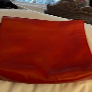 Small red clutch bag.